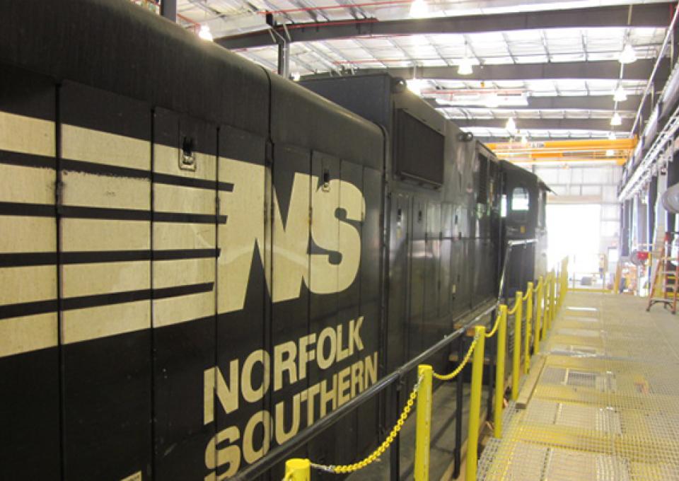 The locomotive and box cars' side shows the locomotive building's length.
