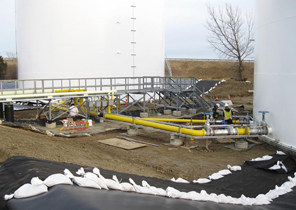 Contaminant liner being installed around fueling tank.