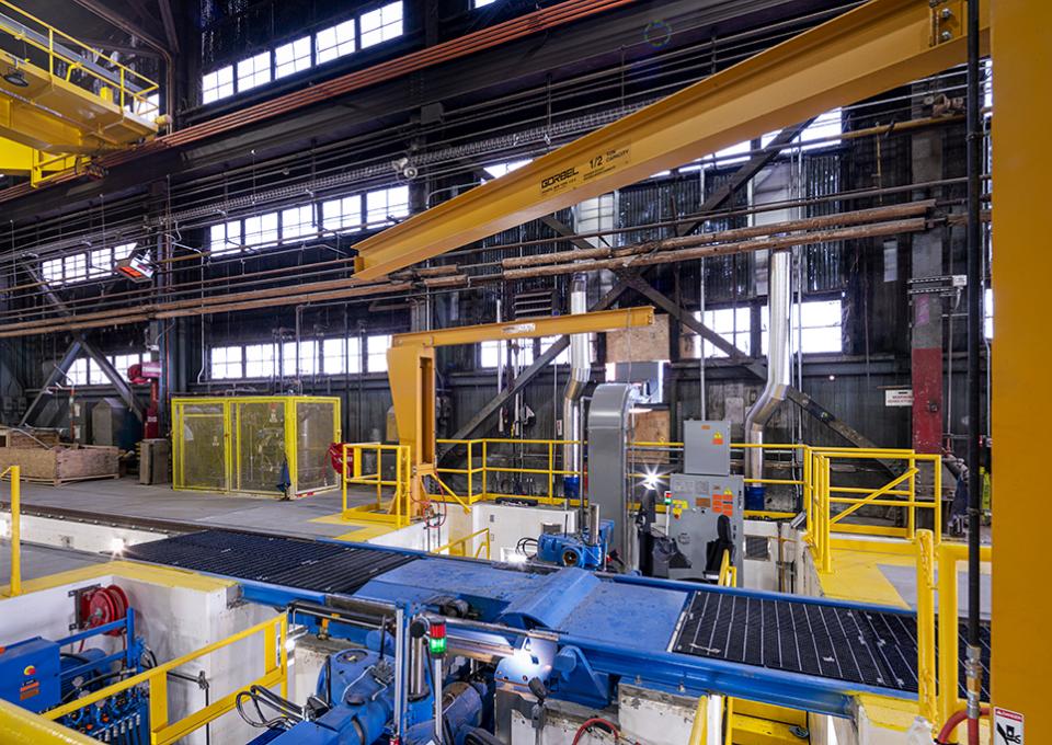 Side view of blue wheel truing machine.