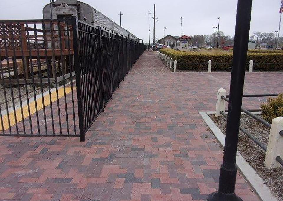 New brick pavement and fencing for station